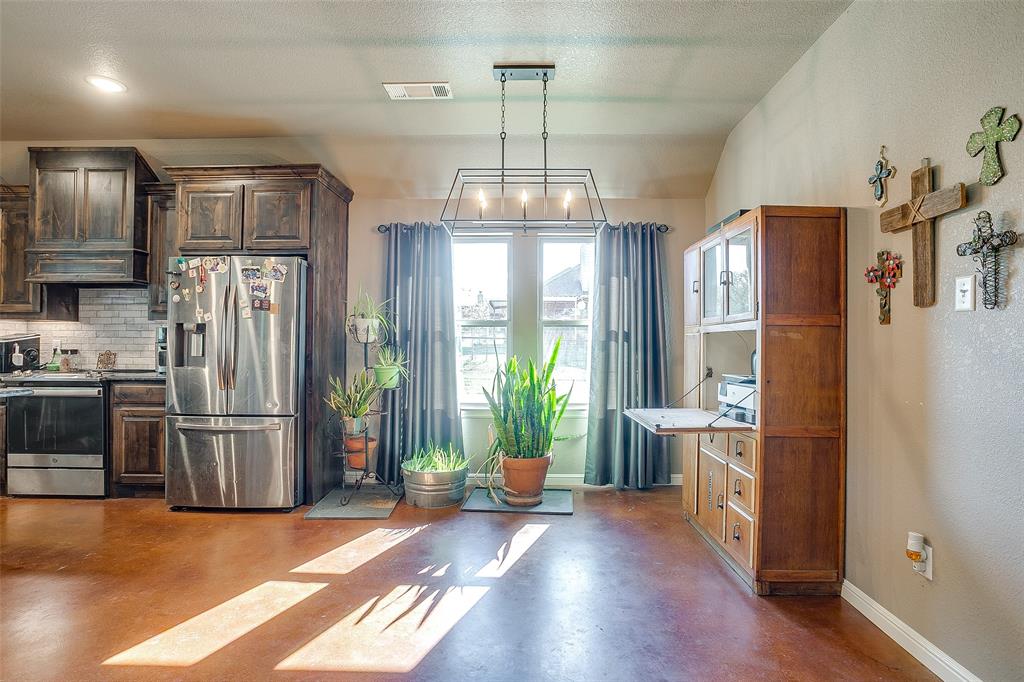 1028 Hope Court Boyd, TX 76023 - Photo 13 of 40 a kitchen with stainless steel appliances granite countertop a refrigerator and a stove top oven