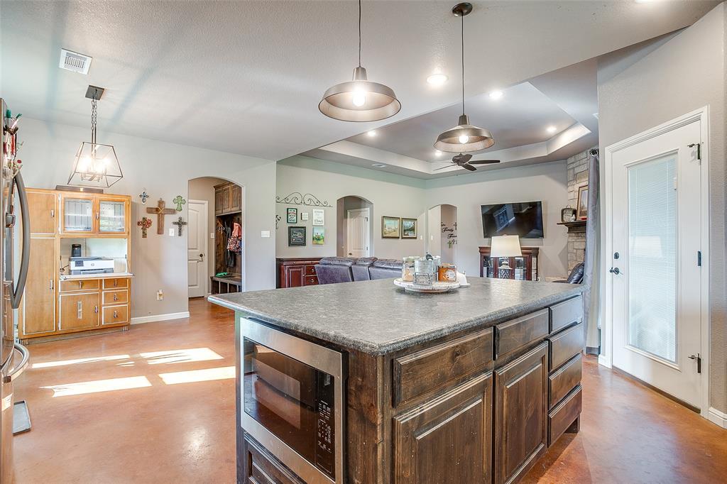 1028 Hope Court Boyd, TX 76023 - Photo 19 of 40 a view of a center island and chandelier