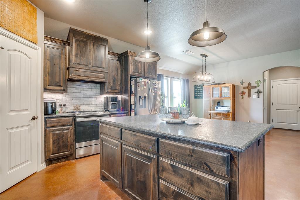 1028 Hope Court Boyd, TX 76023 - Photo 20 of 40 a kitchen with stainless steel appliances granite countertop a sink a stove and refrigerator