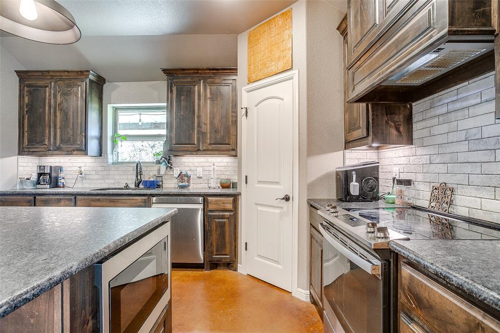 1028 Hope Court Boyd, TX 76023 - Photo 21 of 40 a kitchen with a sink stove and refrigerator