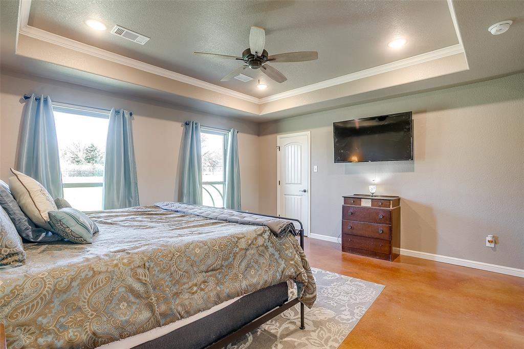 1028 Hope Court Boyd, TX 76023 - Photo 25 of 40 a bedroom with a bed and a flat screen tv