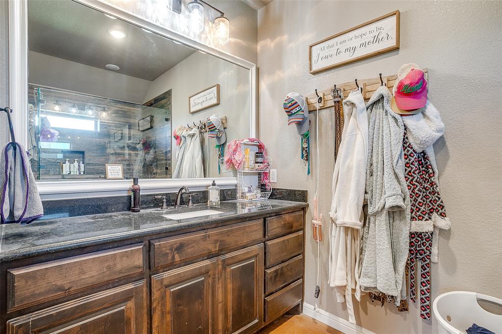 1028 Hope Court Boyd, TX 76023 - Photo 28 of 40 a bathroom with a sink vanity and a mirror