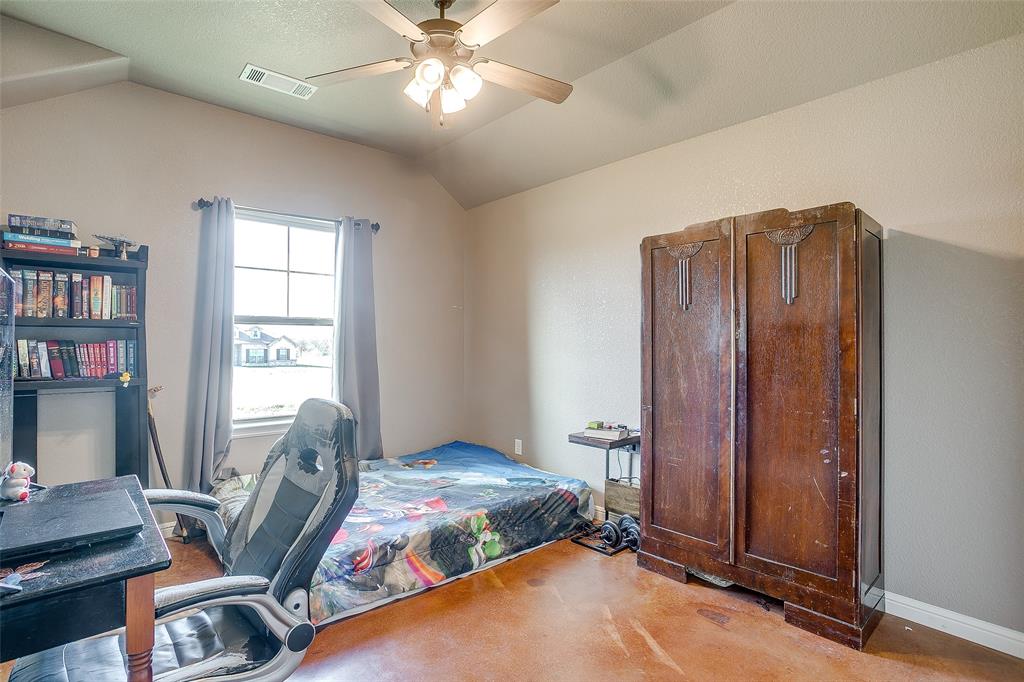 1028 Hope Court Boyd, TX 76023 - Photo 30 of 40 a bedroom with a bed and a bookshelf