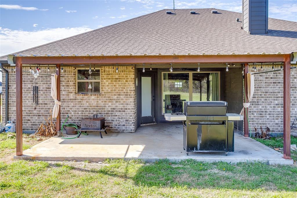 1028 Hope Court Boyd, TX 76023 - Photo 35 of 40 a view of a patio with table and chairs and potted plants