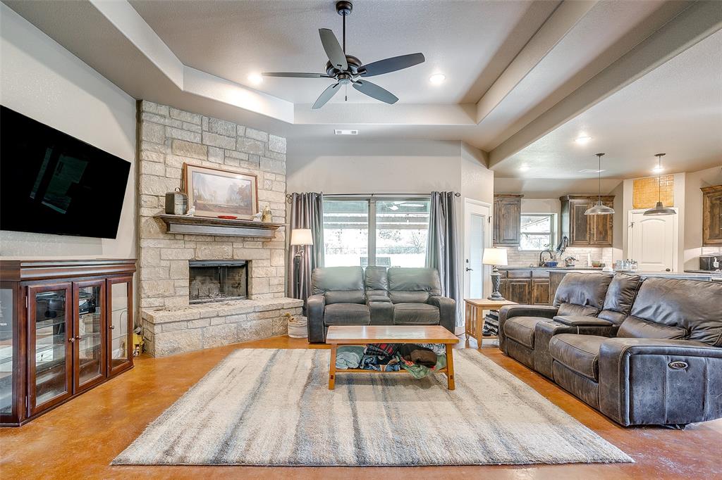 1028 Hope Court Boyd, TX 76023 - Photo 9 of 40 a living room with fireplace furniture and a flat screen tv