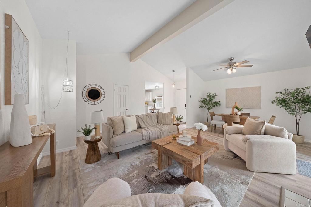 a living room with furniture and a potted plant