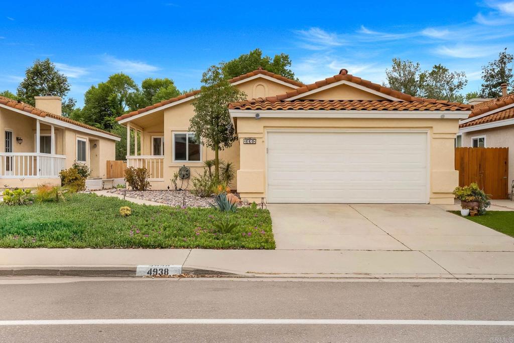 4938 Dulin Road Fallbrook, CA 92028 - Photo 2 of 15 a front view of a house with a yard and garage