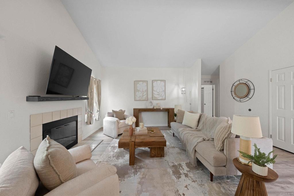 4938 Dulin Road Fallbrook, CA 92028 - Photo 4 of 15 a living room with furniture a fireplace and a flat screen tv