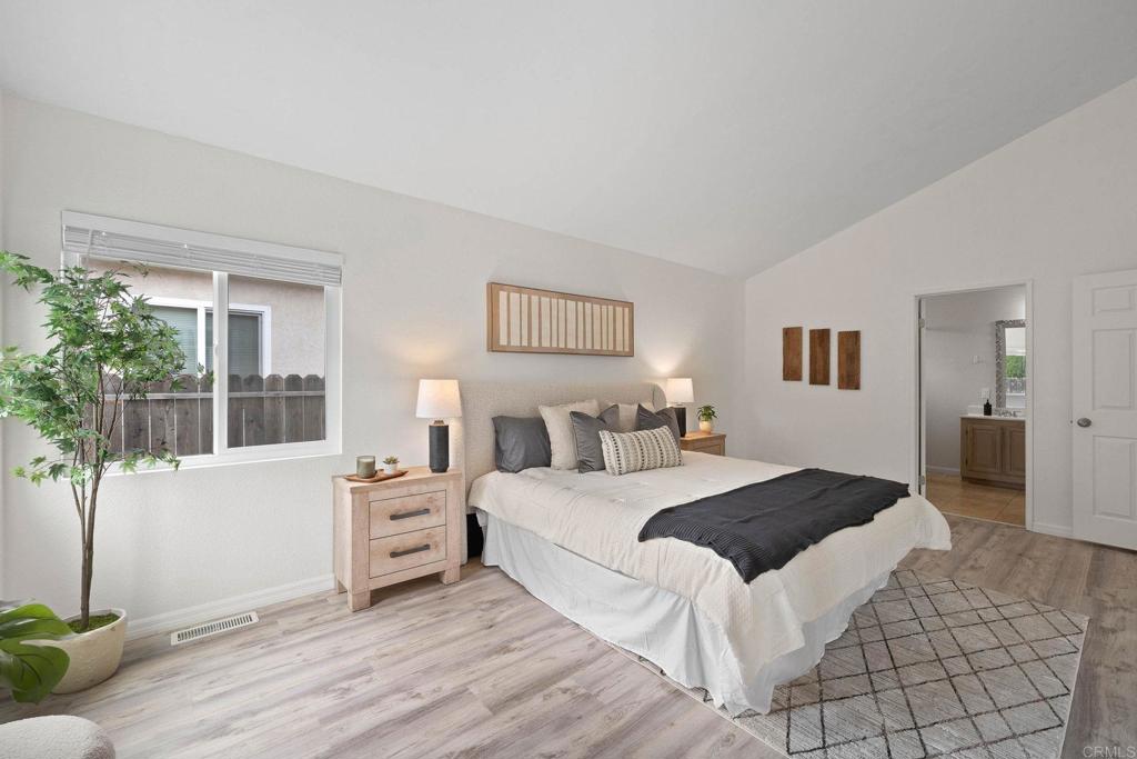 4938 Dulin Road Fallbrook, CA 92028 - Photo 8 of 15 a bedroom with a large bed and a window