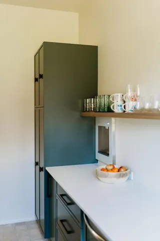 a bathroom with a sink a potted plant and a window