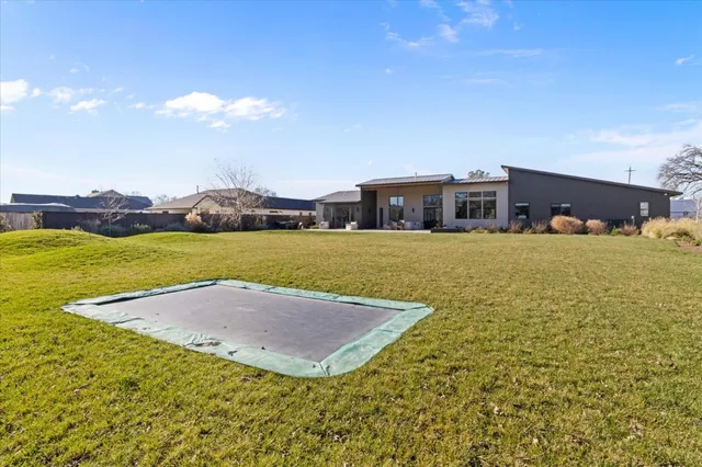 a view of a yard with wooden fence