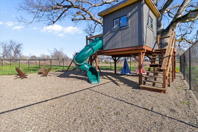 a living room with furniture and wall paintings