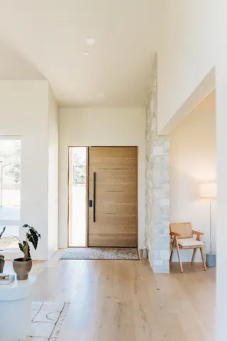 a kitchen with stainless steel appliances kitchen island a large window and cabinets