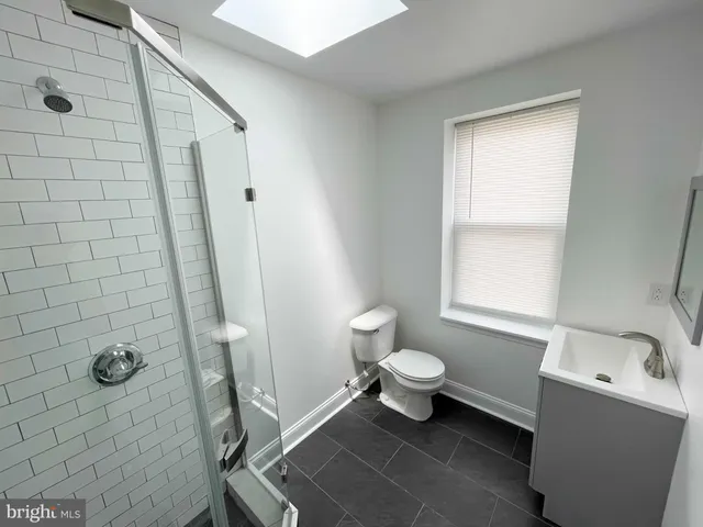 a bathroom with a toilet a sink a bath tub and a shower