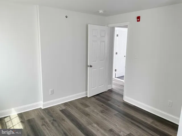 an empty room with wooden floor