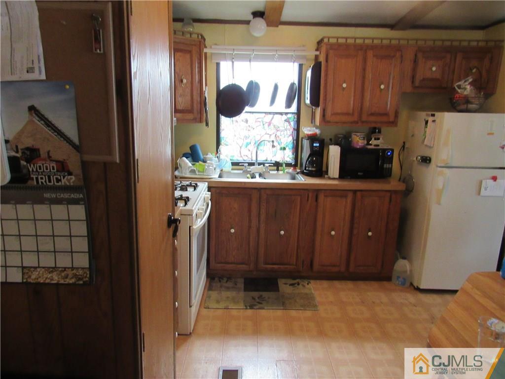 37 Whitman Road, Unit 37 North Brunswick, NJ 08902 - Photo 8 of 20 a view of kitchen with wooden floor