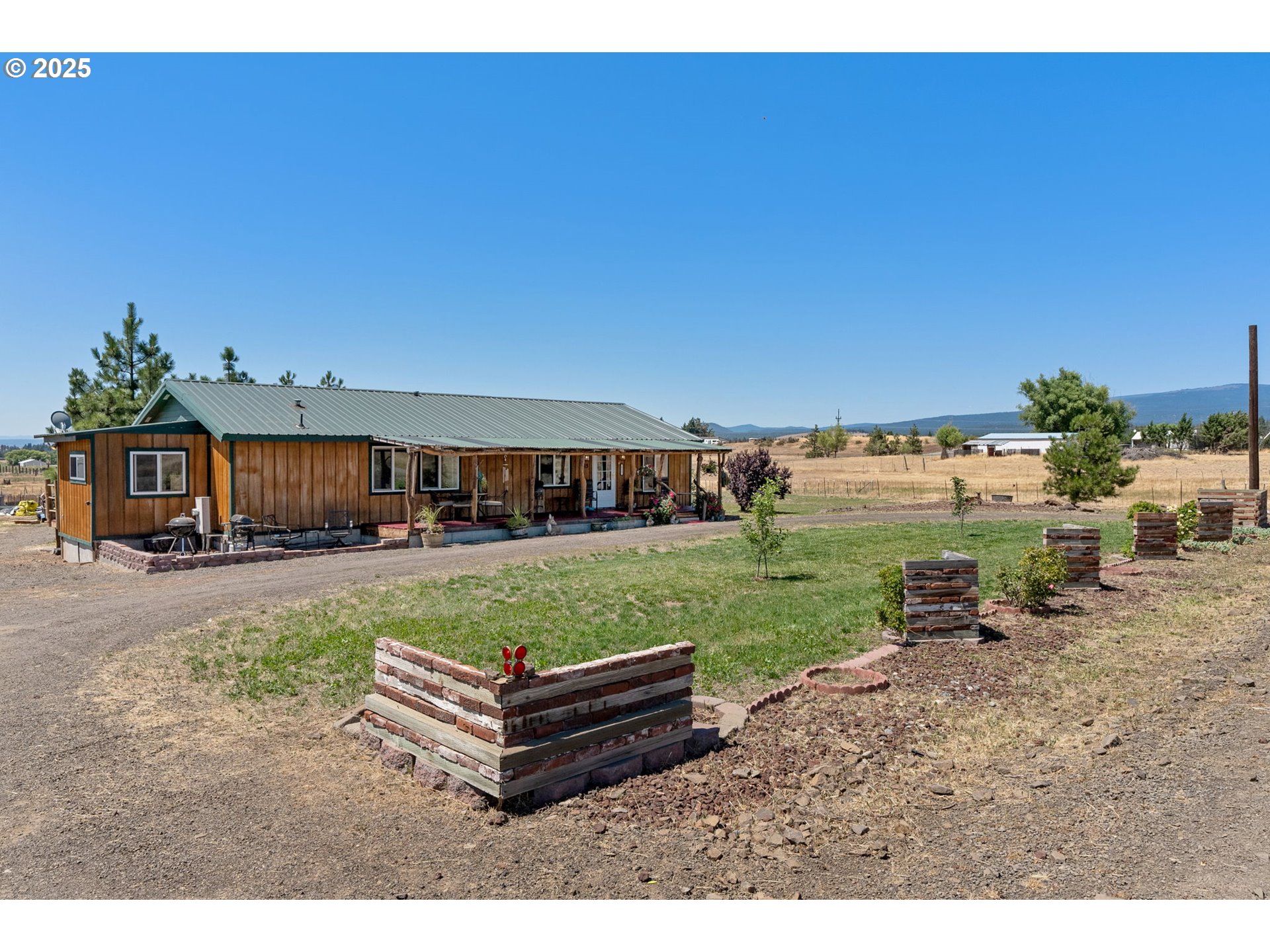 115 Sunset Drive Goldendale, WA 98620 - Photo 25 of 48 a view of a house with backyard and a garden