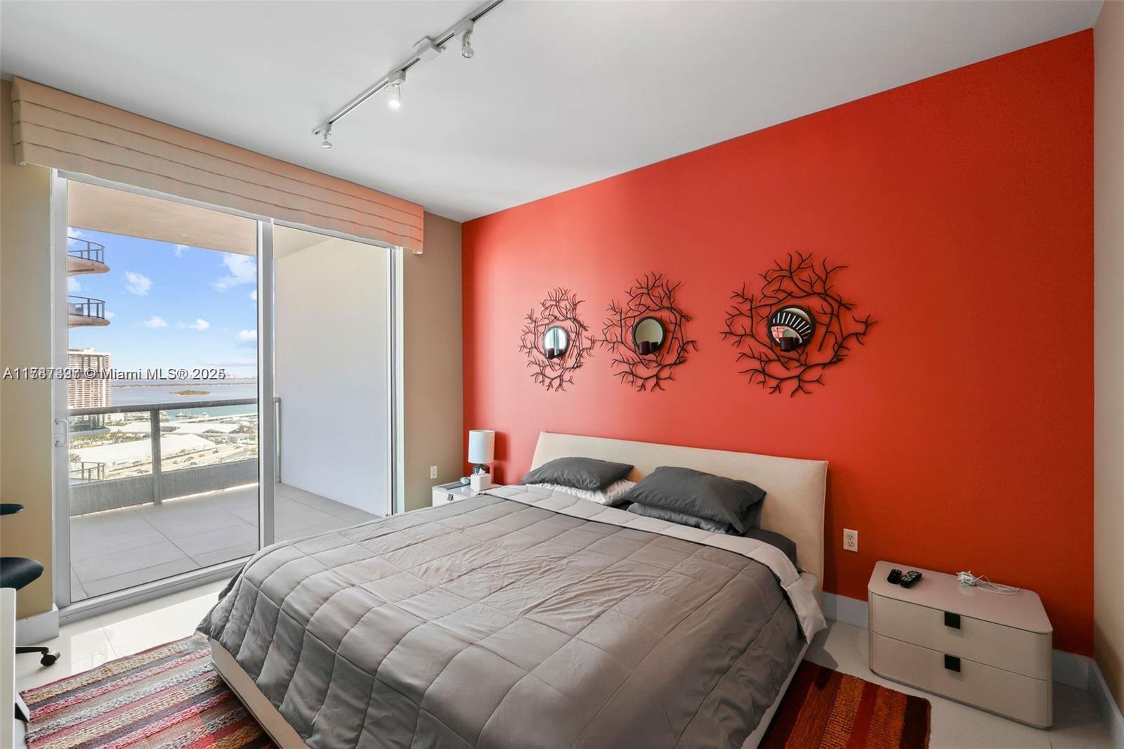 900 Biscayne Boulevard, Unit 2410 Miami, FL 33132 - Photo 11 of 39 a bedroom with a bed and window