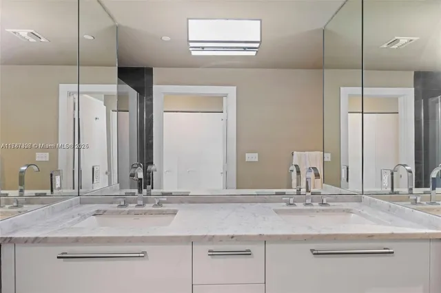 a bathroom with a double vanity sink and a mirror