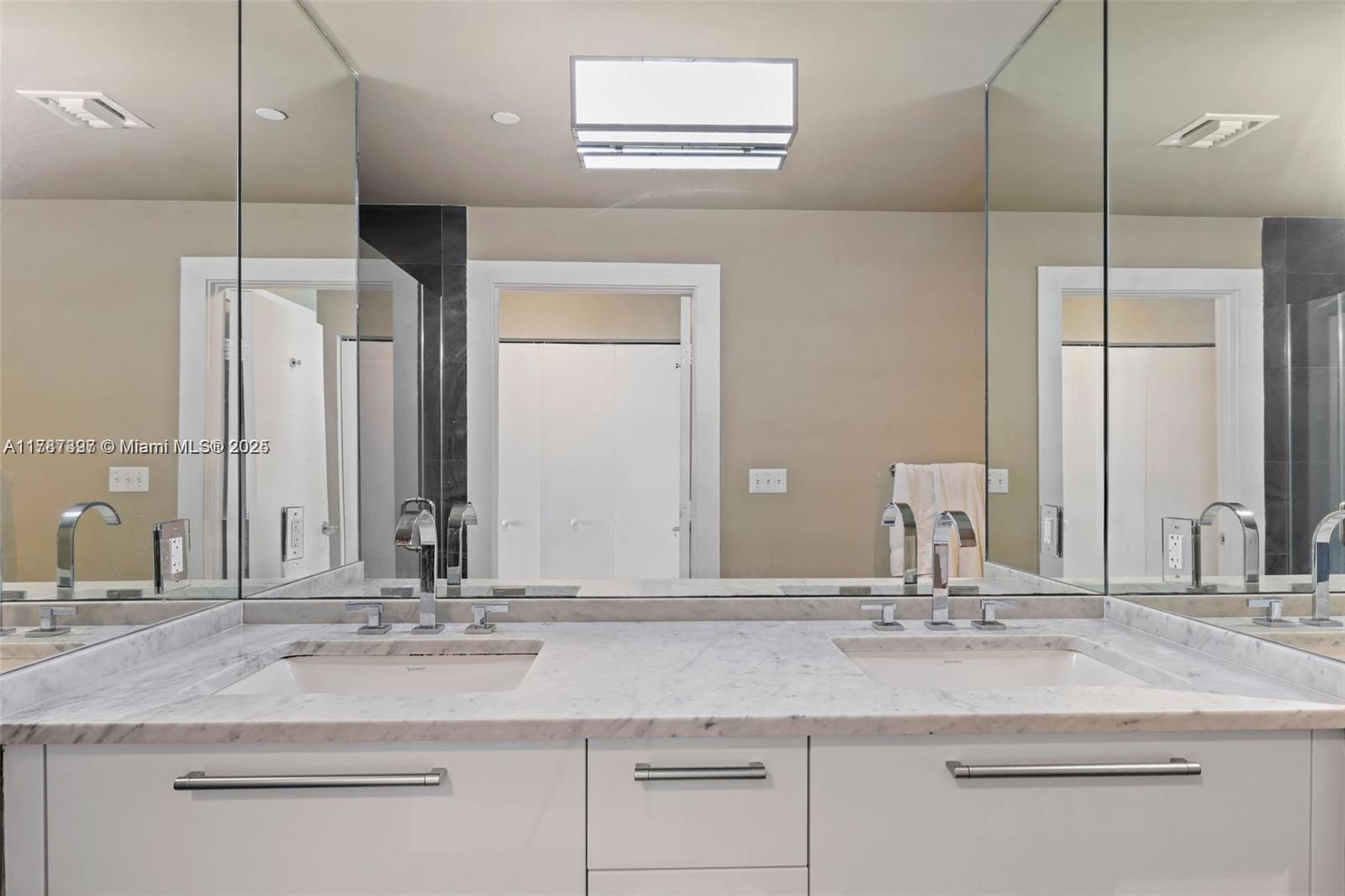 900 Biscayne Boulevard, Unit 2410 Miami, FL 33132 - Photo 16 of 39 a bathroom with a double vanity sink and a mirror