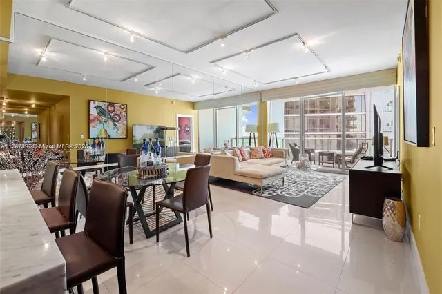 a living room with lots of furniture and a large window