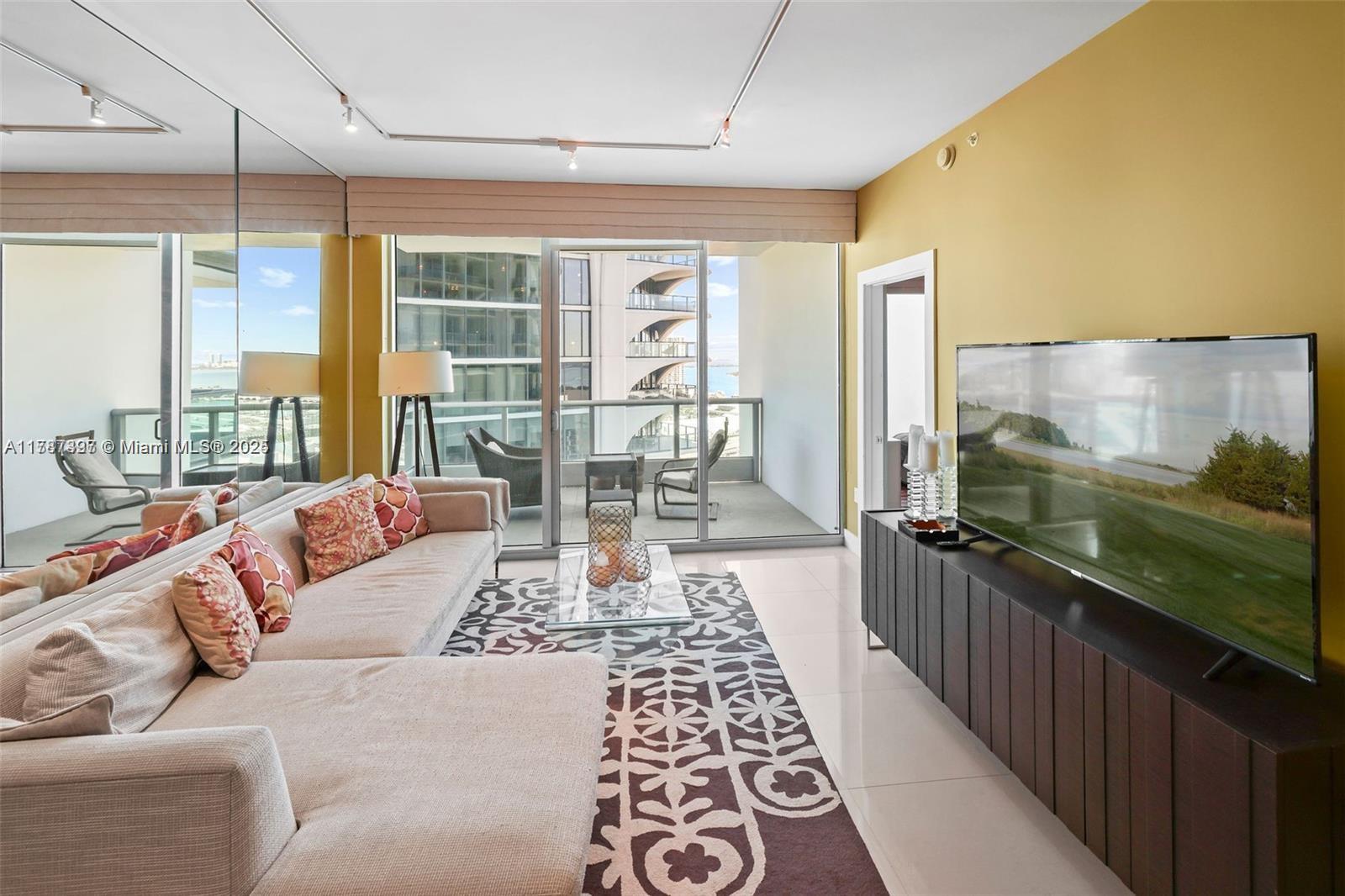 900 Biscayne Boulevard, Unit 2410 Miami, FL 33132 - Photo 6 of 39 a living room with a couch and a table