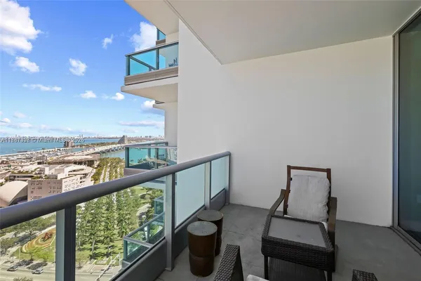 a view of two chairs in the balcony