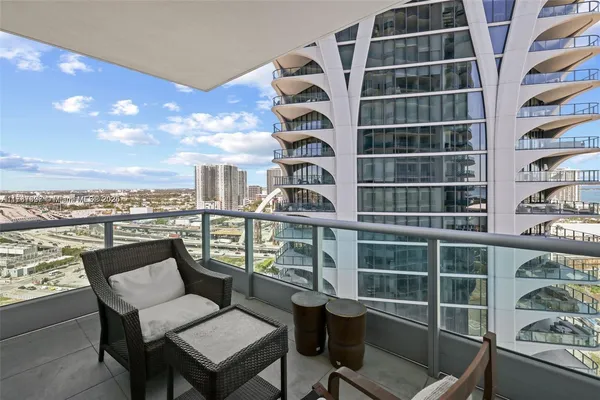 a view of a balcony with chair and table