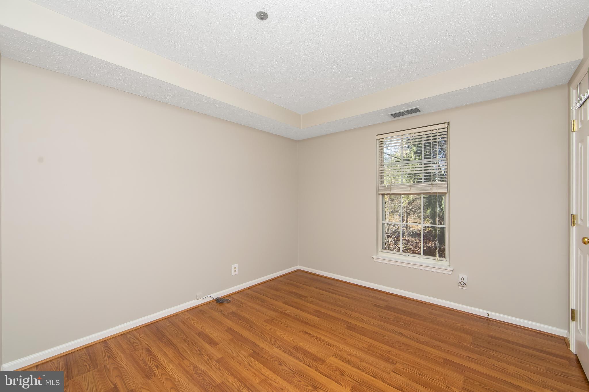 8 Inverness Circle Marlton, NJ 08053 - Photo 25 of 39 an empty room with wooden floor and windows