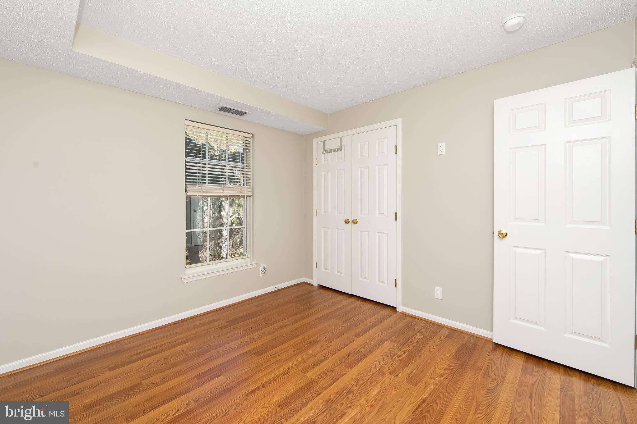 8 Inverness Circle Marlton, NJ 08053 - Photo 26 of 39 an empty room with wooden floor and windows