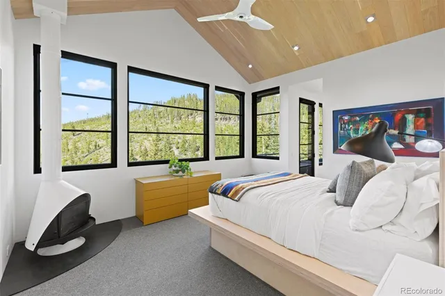 a bedroom with a bed and a large window