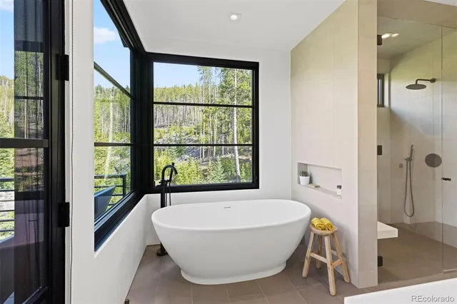 a bathroom with a tub and a window