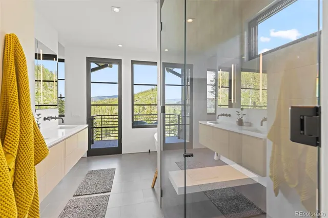 a large bathroom with a tub mirror and sink