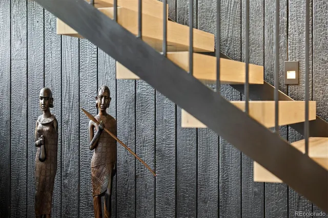 a living room with furniture and floor to ceiling windows