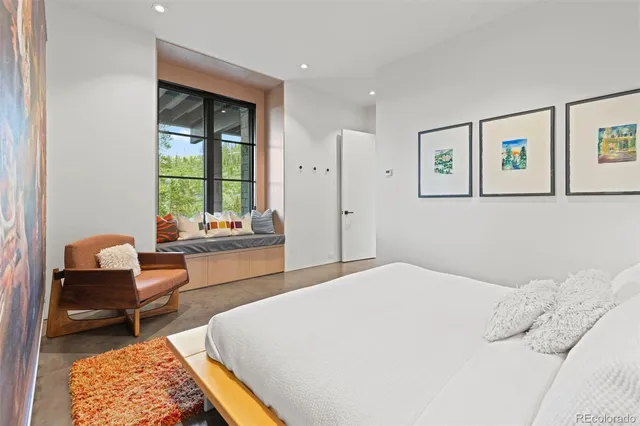 a living room with stainless steel appliances kitchen island granite countertop a sink and a wooden cabinets