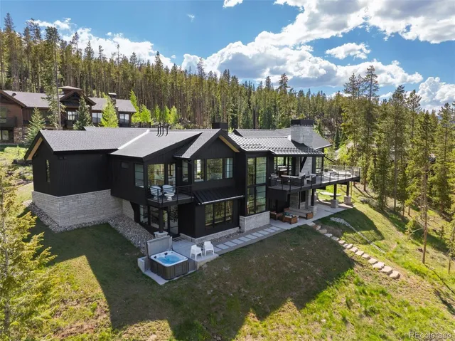 a view of a house with swimming pool next to a yard