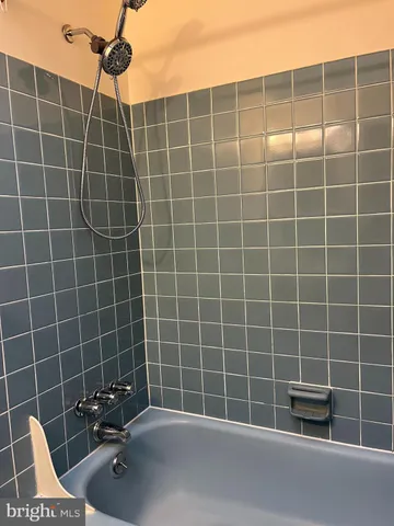 a view of a room with wooden floor and ceiling fan