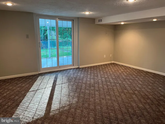 a view of a livingroom with an empty space and a fireplace