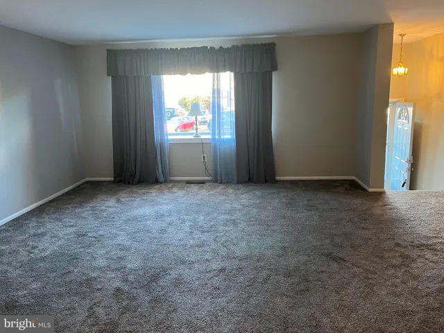 a view of a kitchen with a sink and a refrigerator