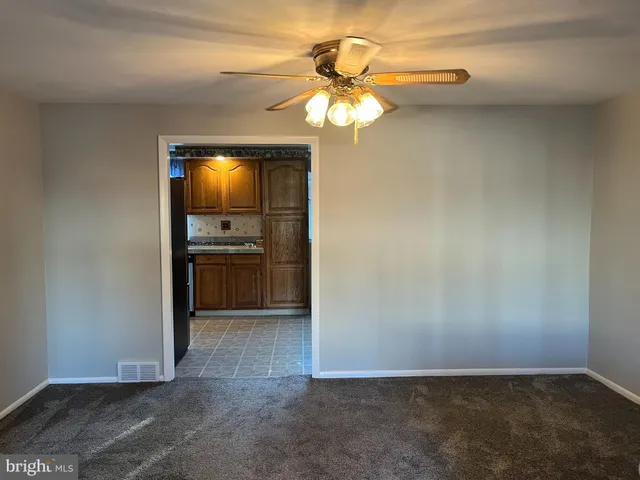 a view of a refrigerator in kitchen and a window