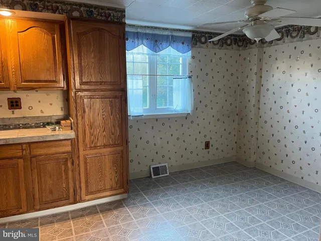 a kitchen with a sink appliances and cabinets