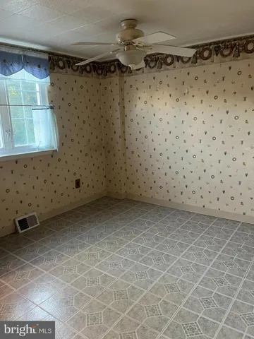 a kitchen with granite countertop wooden cabinets a sink and a window