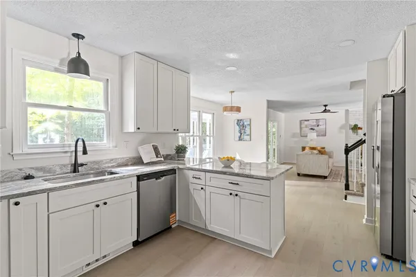 a kitchen with a sink cabinets and window