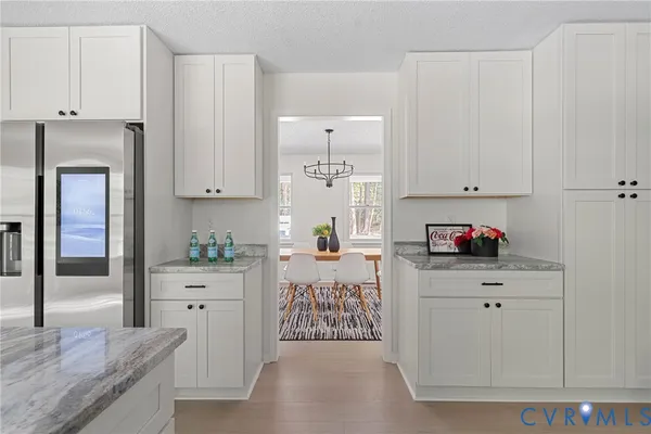 a kitchen with stainless steel appliances a sink stove and cabinets