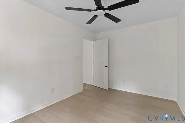 a view of a room with a ceiling fan