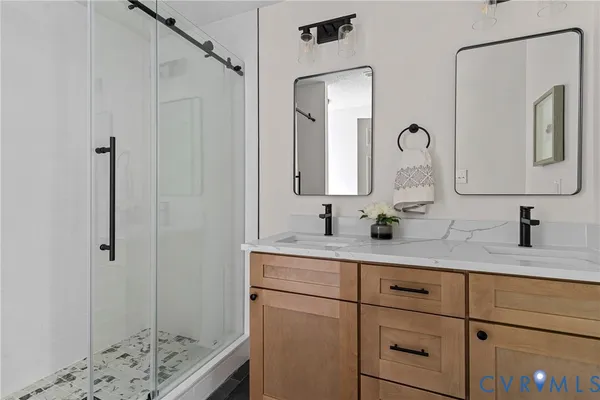a bathroom with a sink a toilet and shower