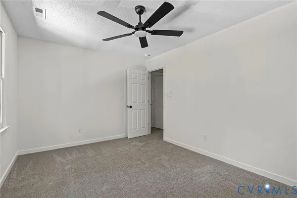 an empty room with a ceiling fan and a ceiling fan