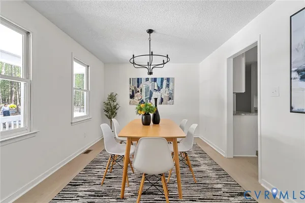 a view of a dining room with furniture window and wooden floor