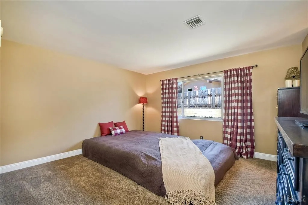 1651 Highlands View Road Alpine, CA 91901 - Photo 19 of 25 a bedroom with a bed and a flat screen tv