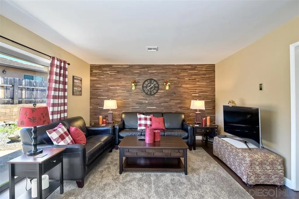 1651 Highlands View Road Alpine, CA 91901 - Photo 4 of 25 a living room with furniture a flat screen tv and a fireplace